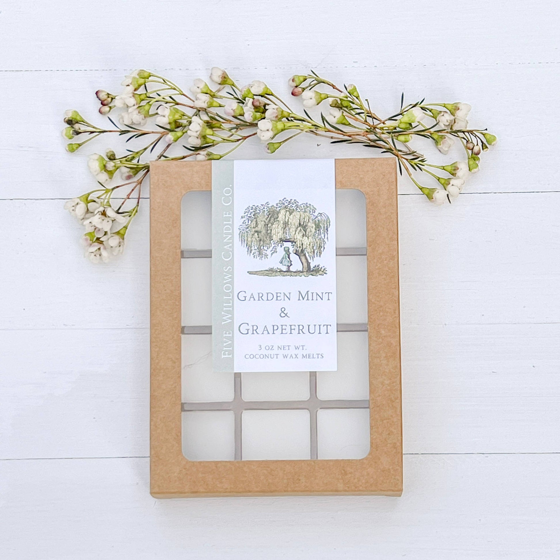 Garden Mint & Grapefruit product packaging with a label on a white wooden surface