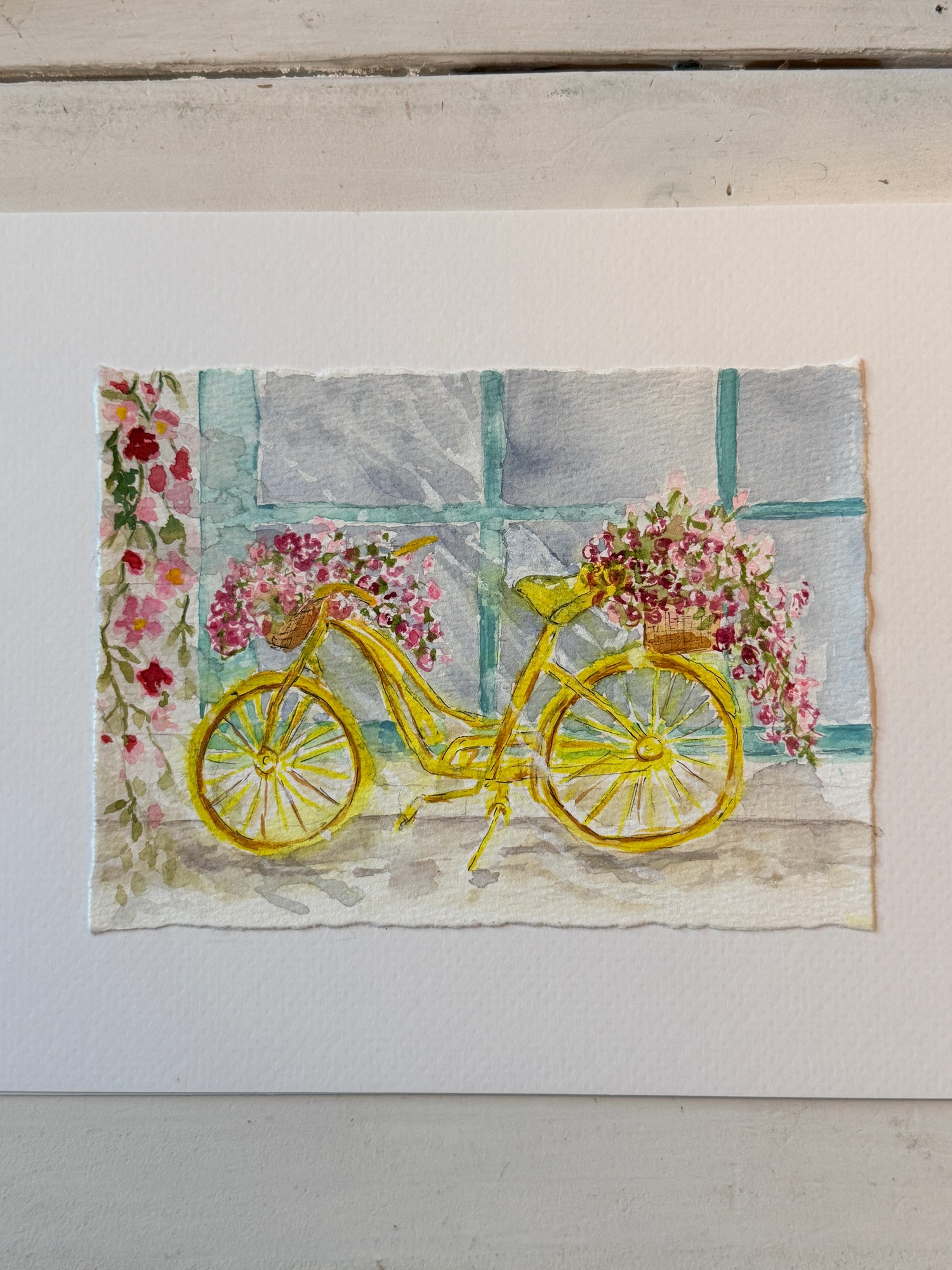 watercolor yellow bicycle with flowers against a light background